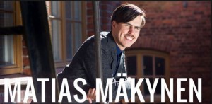 Matias Mäkynen puhuu taloudesta, taustalla tilastoja