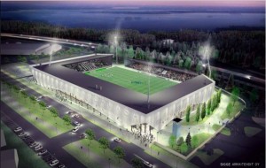 Jalkapallostadionin rakennustyömaa, taustalla kaupunkimaisema