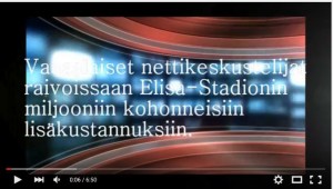 Kari Lajunen puhumassa Elisa Stadionin tapahtumassa, taustalla YouTube-logo