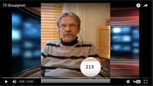 Juri Kadar puhuu vaalivideolla, taustalla Suomen lippu