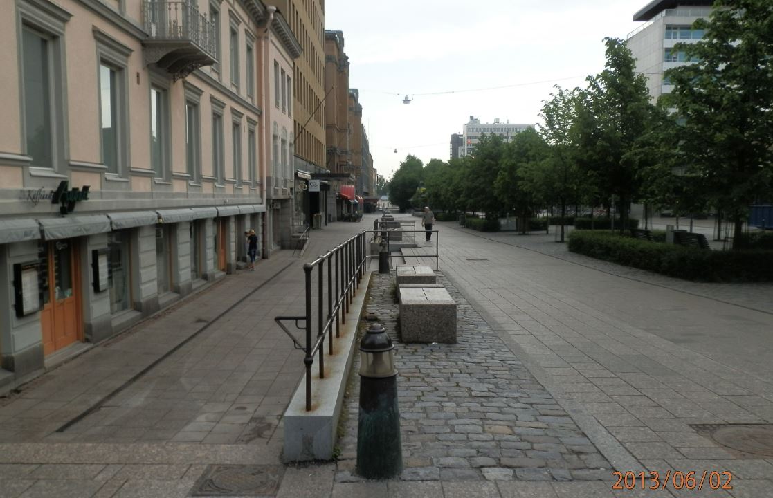 Vaasan Esplanadin puistokatu täynnä vihreitä puita ja kävelijöitä